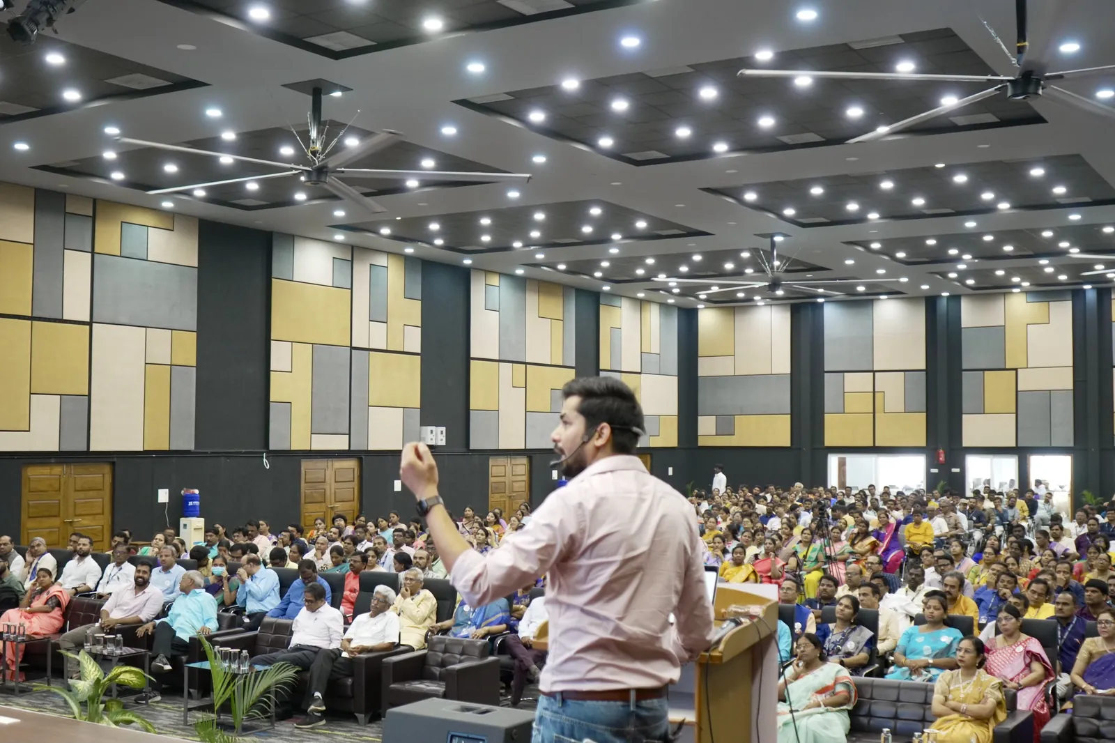 Rajeev Pandey speaking to a packed auditorium of university faculty